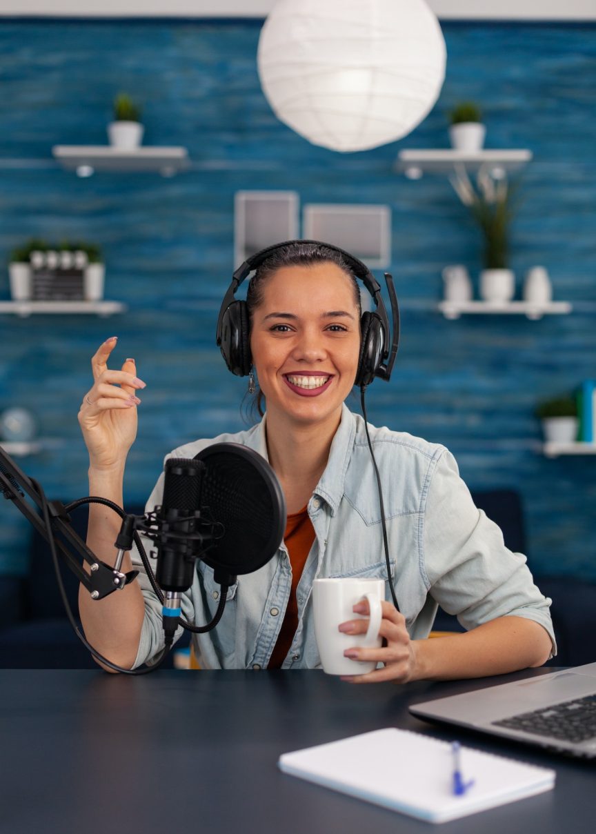 portrait-of-happy-woman-facing-camera-recording-in-home-studio.jpg