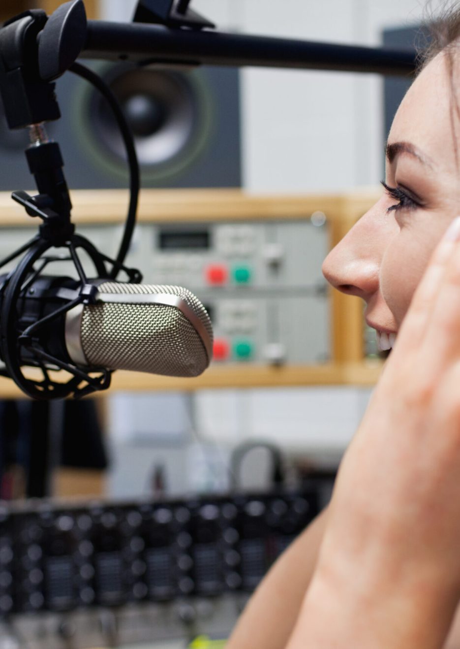 Smiling radio host speaking through a microphone